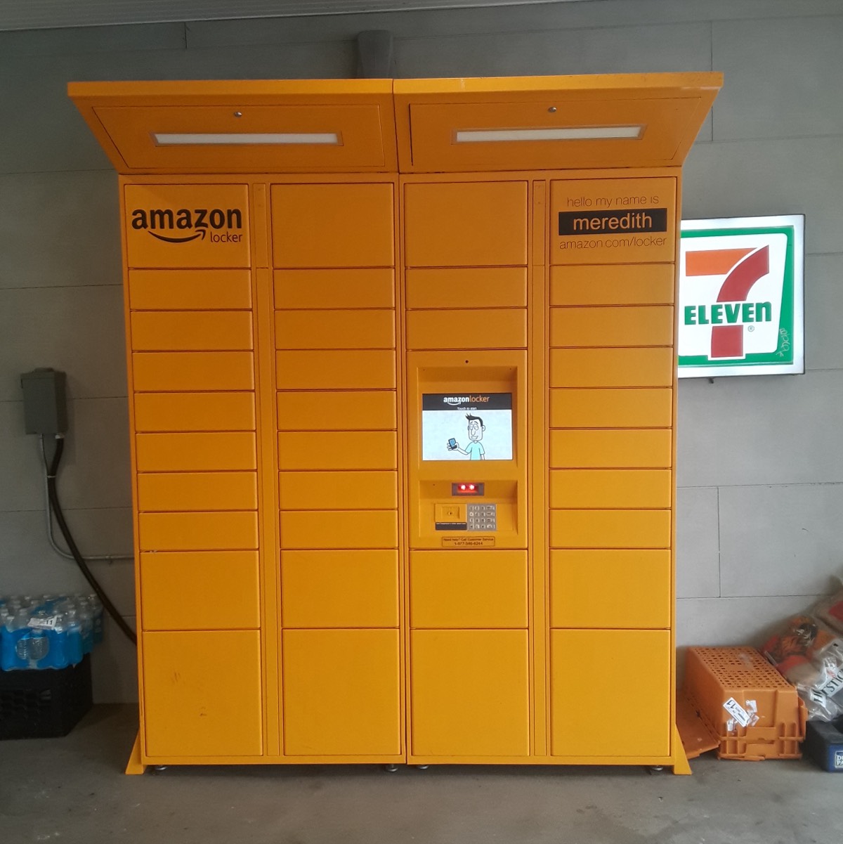 An orange Amazon Locker bank inside a convenience store entrance
